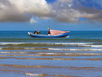 Fishing with traditional coble boat at Alnmouth with Couquet Isand England, UK, July