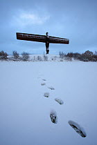 Footsteps in the snow leading up to The Angel of the North, Gateshead, Tyne and Wear, England. November 2010