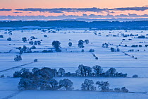 View south over the Somerset Levels from Walton Hill at sunset, with snow, Somerset levels, Somerset, England, UK, December 2010.