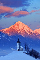 Church of St. Primoz with the Kamnik-Savinja Alps beyond,. January 2010