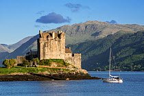 Sailing boat in front of Eilean Donan Castle in Loch Duich, Ross and Cromarty, Scottish Highlands, Scotland, UK, June 2017