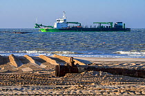 DEME trailing suction hopper dredger Uilenspiegel at sea, used for sand replenishment / beach nourishment to make wider beaches to reduce storm damage, Belgium, 2018