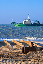 DEME trailing suction hopper dredger Uilenspiegel at sea, used for sand replenishment / beach nourishment to make wider beaches to reduce storm damage, Belgium, 2018