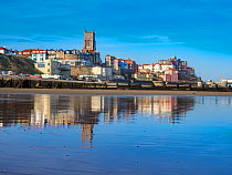 View of Cromer town with reflection on the wet sand. Norfolk, England, UK. October 2017.
