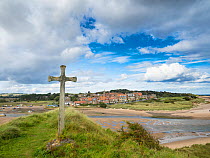Cross on bank overlooking Alnmouth Village, Northumberland, England, UK. September 2017.