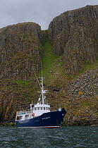 Small cruise ship &#39;Elizabeth G" anchored by Garbh Eilean, the Shiants isles, Hebrides, Scotland. May 2008.