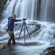 Photographer Guy Edwardes working in river in the Brecon Beacons, Wales, UK, October 2018.