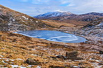 Frozen Llyn Teyrn with Moel Siabod, Conwy in background, view east from Miner&#39;s Track. Snowdonia National Park, Gwynedd, Wales, UK. March 2018.