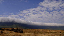 Timelapse of clouds masking Ngorongoro Crater rim, Ngorongoro conservation area, Tanzania.