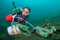 Diver cleaning plastic from a dive site in Lembeh. The group of divers collected three large sacks (much bigger than the small collecting bag pictured) from an area about the size of two tennis courts...