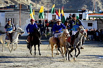 Men riding ponies at a polo tournament in Leh city at 3520 meters altitude, Ladkh, India. September 2018.