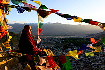 Monk with at Thikshey monastery with prayer flags, at 3260 meters of altitude, Ladakh, India, September 2018.