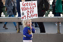 Child holding placard &#39;Greedy Hands off my Future&#39; during Extinction Rebellion demonstration. Five bridges across the Thames were blocked to draw attention to climate change. Westminster, Lond...