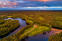 Aerial view of dwelling between two lakes, surrounded by forest. Karula National Park, Vorumaa, Southern Estonia. June 2018.