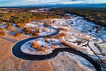Meandering Mustjogi river with frozen lakes, aerial view. Border with Latvia. Valgamaa, Estonia. December 2016.