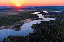 Sunrise over river and forest in Emajoe Suursoo Nature Reserve, aerial view. Tartumaa, Eastern Estonia. May 2016.