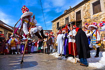 Man leaping over stick in traiditional costume, Carnival of Zamarrones, Belmonte village, Polaciones valley, Cantabria, Spain.