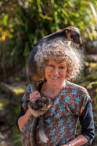 Wildlife carer Margit Cianelli with Lumholtz tree kangaroo (Dendrolagus lumholtzi) &#39;Kimberley&#39; on her shoulder. Lumholtz Lodge, Atherton Tablelands, Queensland, Australia. Model released.