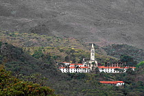 Church and buildings surrounded by Cerrado forest. Parque do Caraca, Minas Gerais, Brazil. 2010.