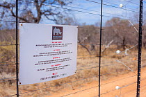 A sign on a fence of a game reserve bordering South Africa's Kruger National Park warns poachers that the horns of the reserve's rhinos have been treated and are unfit for human consumption. September...