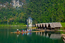 Tourists on raft outside an ecolodge at Cheow Larn Lake. Khao Sok National Park. Suratthani Province, Thailand. February 2011