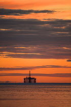 Oil rig sihouetted at dawn. Moray Firth, Scotland, UK.
