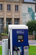 Electric car charging point in front of Saxon Switzerland National Park information centre. Eurasian lynx (Lynx lynx) branding on wall. Bad Schandau, Saxony, Germany.