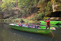 Tourists in boat on Kamenice River. Bohemian Switzerland National Park, Czech Republic.