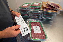 Wild venison producer, Forest to Fork, demonstrating Quality Assurance certification for culled deer. Meat products in background. Culbokie, Ross and Cromarty, Scotland, UK.