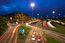 Evening rush hour with trails from car lights, long exposure. Charing Cross, Glasgow, Scotland, UK.