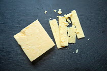 Cheddar cheese on slate board