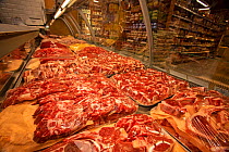 Meat for sale at butchers counter in supermarket,, North London, England, UK.