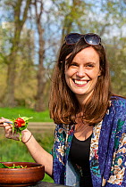 Woman enjoying a vegan picnic salad, North London, England, UK, March 2019. Model released.