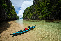 Kayak in the entrance channel to the Big Lagoon, Miniloc Island at low tide, Bacuit Archipelago, Palawan, the Philippines.