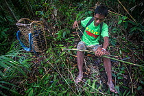 Batak man making rattan hook for tree-climbing aid in Cleopatras Needle Critical Habitat, Palawan, the Philippines. September 2016.