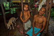Batak man and his daughter in his house in Sitio Kalakwasan, Cleopatra&#39;s Needle Critical Habitat, Palawan, the Philippines. October 2016.