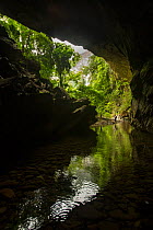 Tourists in the passage from the Deer Cave into the Garden of Eden Valley in Gunung Mulu National Park, UNESCO World Heritage Site, Sarawak, Malaysian Borneo.