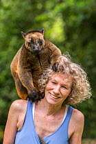 Wildlife carer Margit Cianelli with Lumholtz tree kangaroo (Dendrolagus lumholtzi) &#39;Geoffrey&#39; which she raised from a joey, Atherton Tablelands, Queensland, Australia. Model released.