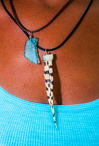 Woman wearing a Lionfish (Pterois volitans) necklace in The Bahamas. The species is invasive and fisherman are encouraged to cull them.