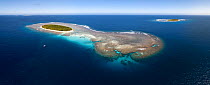 Aerial panorama of Fonua'one'one Island in the Vava'u island group of the Kingdom of Tonga, with a boat in the foreground for scale. From this perspective, it is clear that the island comprises only a...