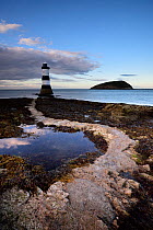 Penmon Lighthouse and Puffin Island at low tide. Anglesey, Wales, UK, August