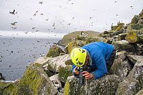 Glasgow University seabird researcher Dr Ruedi Nager documenting plastic in birds&#39; nests, Shiant Isles, Outer Hebrides, Scotland, UK. July, 2018.