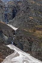 Snow masses from avalanches remaining well into spring in Valsavarenche after a winter with huge destructive avalanches, Valsavarenche, Gran Paradiso National Park, Aosta Valley, Italy