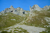 Pica de Balbin and Pena Fresnidiello limestone peaks either side of the Canal de Lechangos scree-filled gulley above the Vega Fresnidiello, near Sotres, Picos de Europa, Asturias, Spain, August 2016.