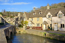 Bridge over the Bybrook river and medieval street in the Cotswolds village of Castle Combe, Wiltshire, UK, November 2017.