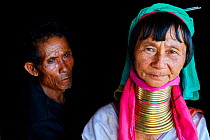Portrait of a Kayan Lahwi woman with her husband. The Long Neck Kayan (also called Padaung in Burmese) are a sub-group of the Karen ethnic people from Burma. They wear spiral coils around their neck a...
