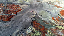 Aerial shot of mining waste and other toxic by-products collected in dry stacks and a big pond, in a large copper mining  and hydrometallurgical process plant complex near Gerena, Seville, Spain, Augu...