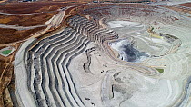 Aerial shot of an open mine pit and process plant in a copper mining and hydrometallurgical process plant complex, near Gerena, Seville, Spain, August 2018.