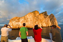 Tourists taking pictures of Kicker Rock, San Cristobal Island, Galapagos. April 2013.