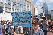 &#39;The seas are rising and so are the grandmothers&#39; banner at Extinction Rebellion climate change protest march. Bristol, England, UK. 16 July 2019.